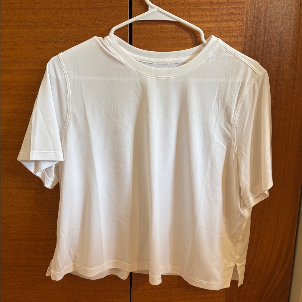 Women’s lululemon white work out top. Size 10. Short but not cropped.